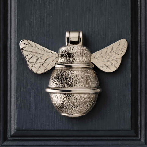 Close-up of polished nickel bumble bee door knocker showing detailed textured body and bright nickel finish