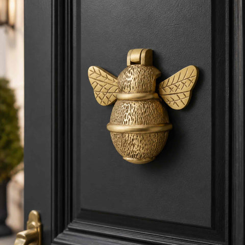 Macro close-up of the Satin Brass Bumble Bee Door Knocker showing detailed textured casting and decorative wing pattern.