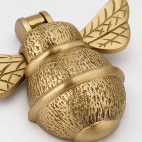 Angled product view of a Satin Brass Bumble Bee Door Knocker showing the solid brass construction and decorative detailing.