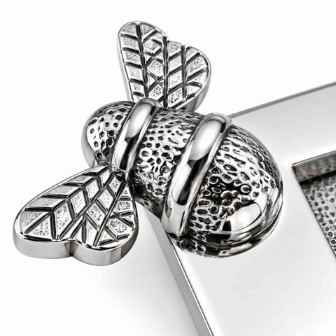 Close-up of decorative bumble bee detailing on polished chrome "LETTERS" letter plate