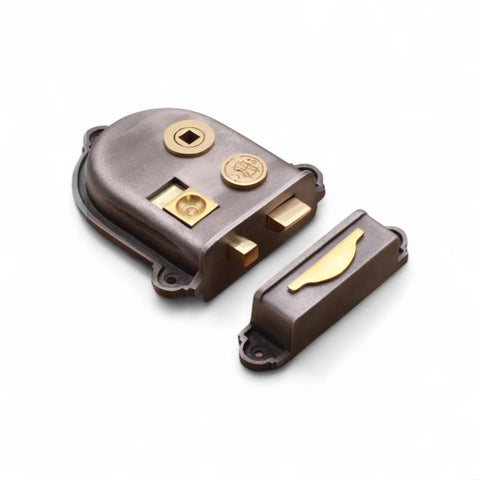 Side view of a Cromwell cast iron rim lock showing latch, spindle hole, and decorative brass detailing.