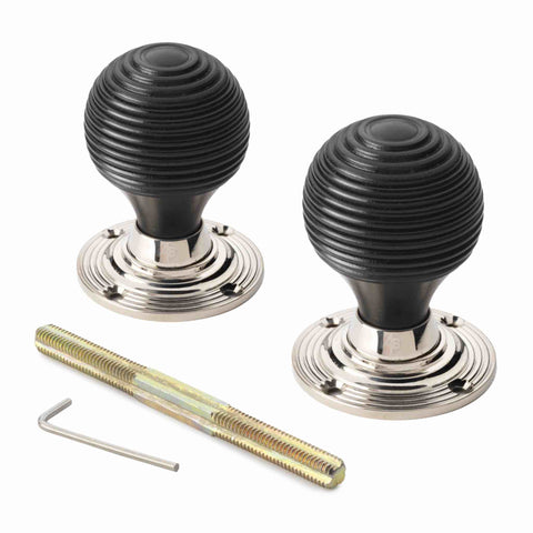 Pair of ebonised black beehive door knobs with polished nickel reeded backplates, threaded spindle and Allen key