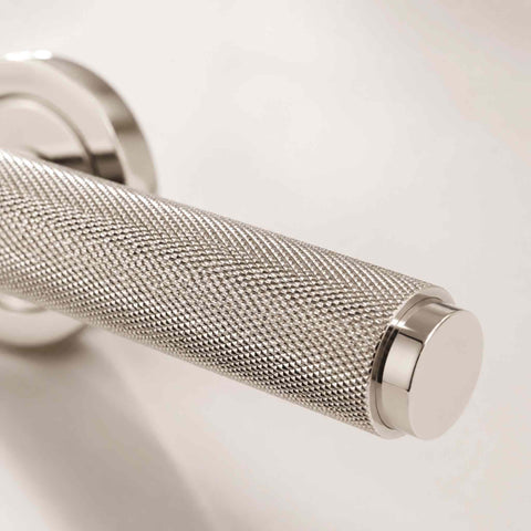 Close-up of the knurled polished nickel door handle showing the precision-machined diamond pattern for enhanced grip and premium appearance.