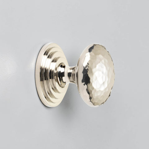 38mm solid polished nickel hammered cupboard knob with stepped backplate fitted to grey cabinet door