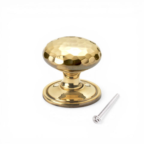 38mm solid aged brass hammered cupboard knob with plain backplate and fixing screw on white background