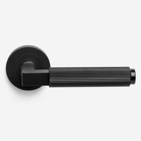 Black reeded lever door handle pair with round roses displayed on a white background, front profile product image.