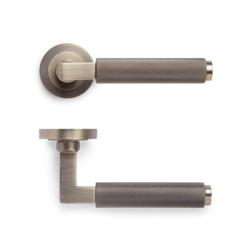 Side profile of matt antique brass knurled lever door handle on round rose