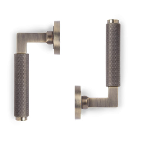 Back view of matt antique brass knurled lever door handle on round rose