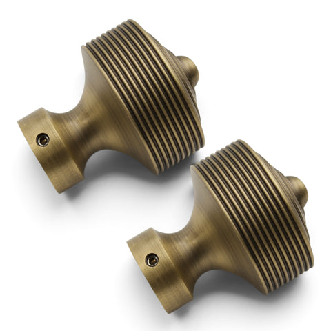 Pair of matt antique brass reeded door knobs showing side profile and grub screw fixings