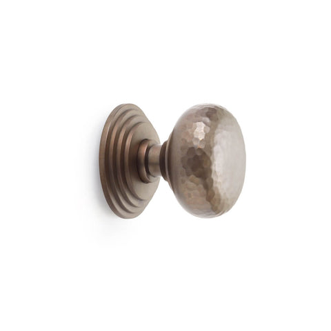 Hammered matt antique cottage centre door knob with stepped backplate, side profile on white background