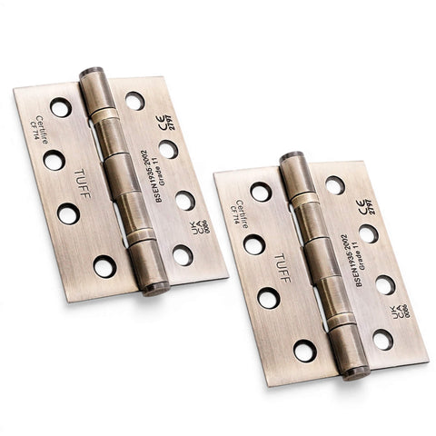 Aged brass CE11 ball bearing butt hinges pair, 100mm steel fire rated door hinges on white background.