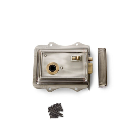 Pewter and antique brass Olde Victorian rim lock with keep and fixing screws on white background