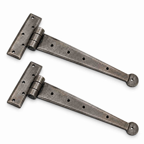 Angled view of pewter wrought iron Penny End T hinges with traditional penny end design