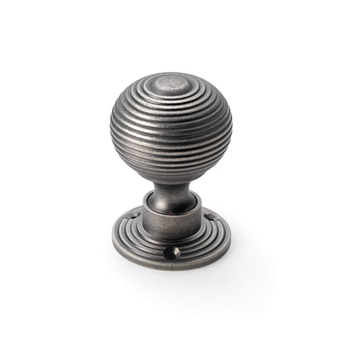 Single pewter reeded beehive mortice door knob on round rose backplate.