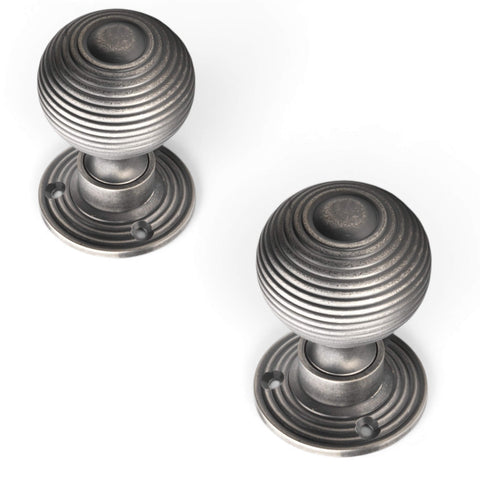 Top view of pewter reeded beehive mortice door knob pair with circular stepped backplates.