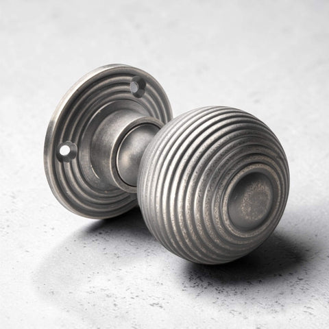 Close-up angled view of pewter reeded beehive mortice door knob with textured pewter finish.