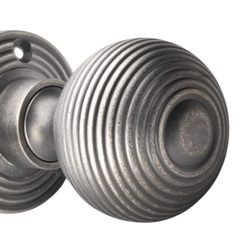 Detailed close-up of pewter reeded beehive mortice door knob showing circular groove design.