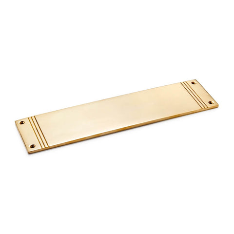 Unlacquered polished brass reeded push plate, 305mm x 75mm, angled view showing bright finish and stepped detailing