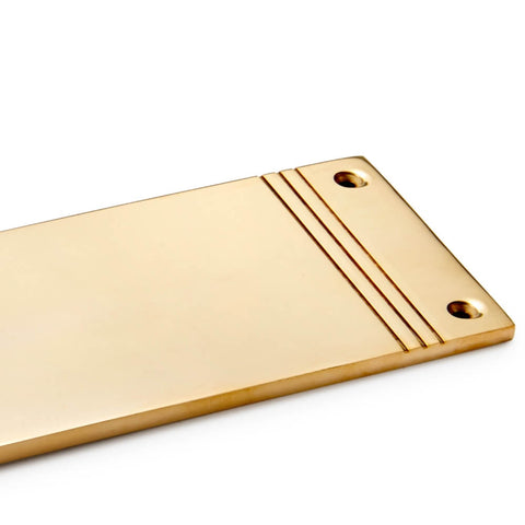 Close-up of reeded detailing on solid brass push plate in unlacquered polished brass with countersunk fixing holes