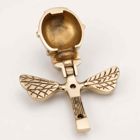 Polished brass bumble bee door knocker shown open with rear fixing plate and mounting holes visible