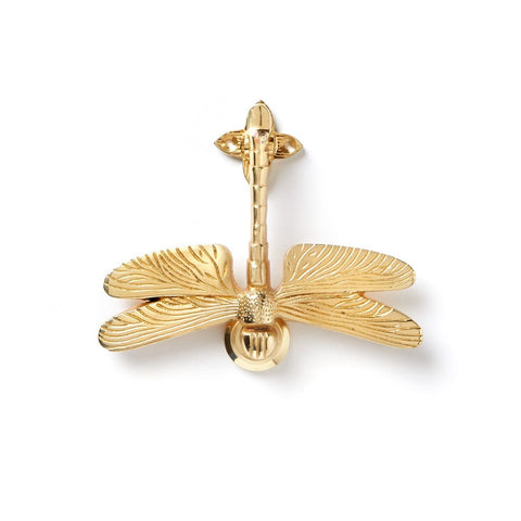 Polished brass dragonfly door knocker displayed on white background.