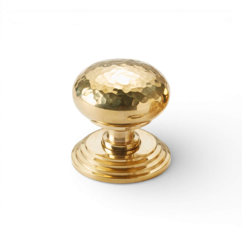 Hammered mortice door knob on stepped backplate in unlacquered polished brass finish