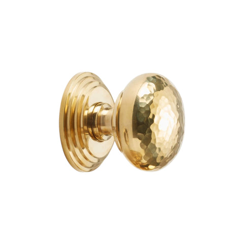 Side view of hammered mortice door knob on stepped backplate in unlacquered polished brass finish