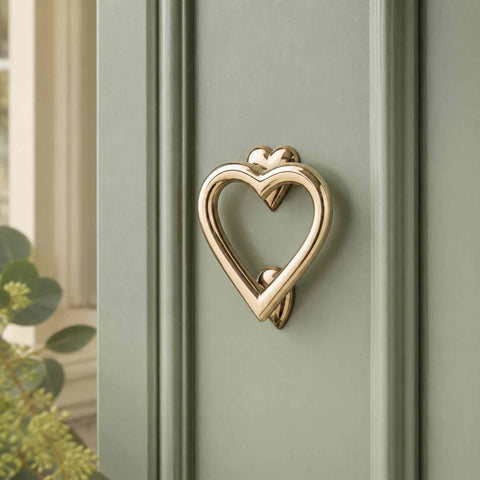 Close-Up of Unlacquered Polished Brass Heart Door Knocker on a Traditional Sage Green Entrance Door