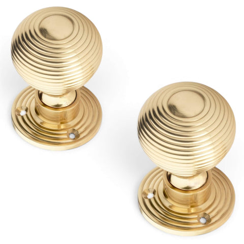 Pair of Polished Brass Hollow Beehive Door Knobs on Reeded Round Backplates