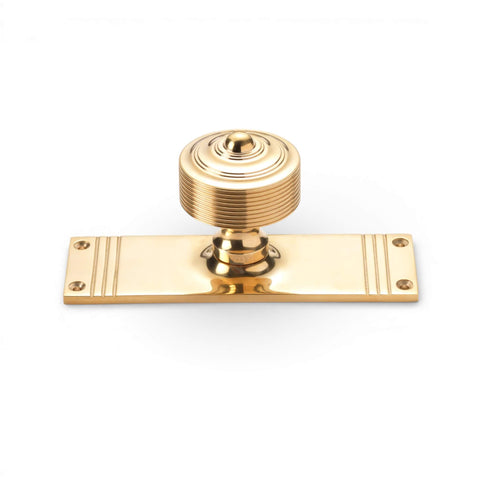 unlacquered polished brass reeded door knob on rectangular backplate solid brass door furniture