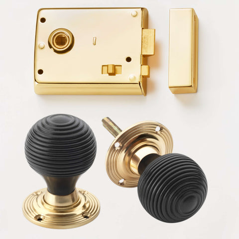 Polished brass rim latch lock with ebonised and brass beehive door knobs