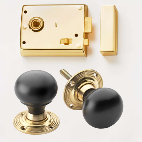 Polished brass rim latch lock with ebonised and polished brass bun door knobs