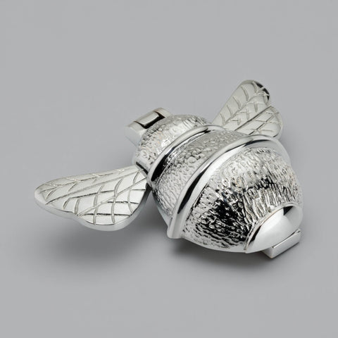 Polished chrome bumble bee door knocker shown at an angle, highlighting textured body, smooth bands and engraved wing detail.