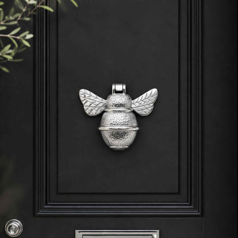 Polished Chrome Bumble Bee Door Knocker displayed on a black front door with matching chrome hardware