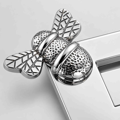 Close-up of detailed bumble bee design on polished chrome solid brass letter box plate