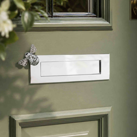 1. Polished chrome Bumble Bee letter box plate fitted to a traditional green front door