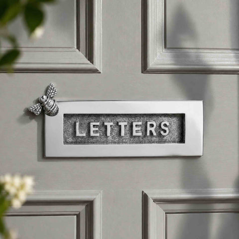 Polished chrome Bumble Bee LETTERS letter plate fitted to a traditional grey front door