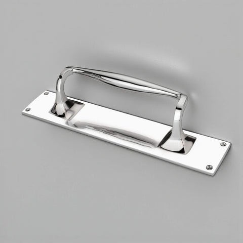 Angled view of polished chrome door pull handle on rectangular backplate with four pre-drilled fixing holes.