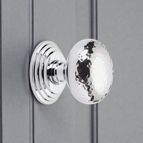 Hammered polished chrome cottage centre door knob with stepped backplate, fitted to painted panelled door