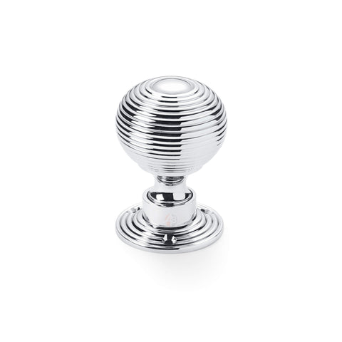 Single polished chrome reeded beehive mortice door knob on round rose backplate.