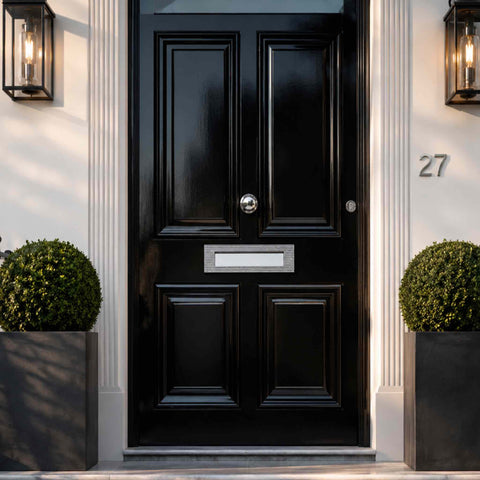 Polished chrome reeded letter plate fitted to a traditional black entrance door