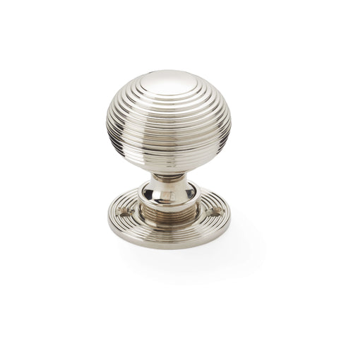 Single polished nickel reeded beehive mortice door knob with circular reeded rose on white background