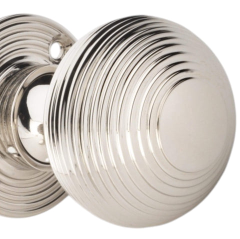 Close-up detail of polished nickel reeded beehive door knob showing concentric ring design and polished finish