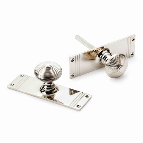 Polished nickel reeded beehive mortice door knob pair with tall rectangular backplates, spindle and fixing holes.