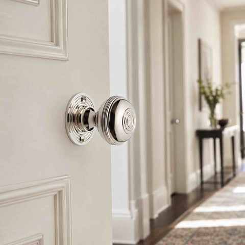 Polished nickel Bloxwich mortice door knob fitted to a traditional internal door, creating a bright and elegant finish.