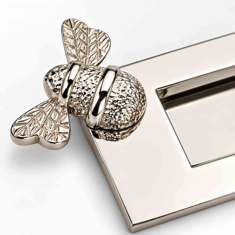 Close-up of polished nickel Bumble Bee letter plate showing the intricate textured bee and highly polished finish