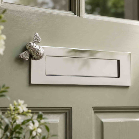 Polished nickel Bumble Bee letter box plate fitted to a traditional sage green front door