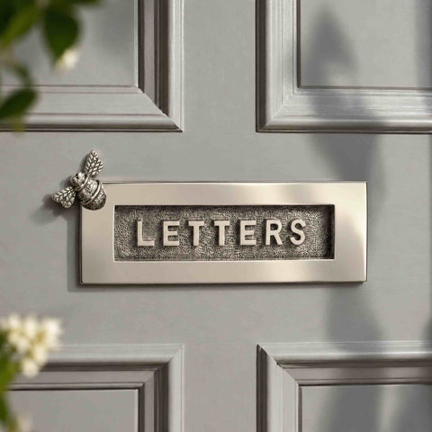 Polished nickel Bumble Bee “LETTERS” letter plate fitted to a traditional grey panelled front door