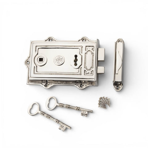 Polished nickel Davenport rim lock set with keep, fixing screws and two keys on a white background