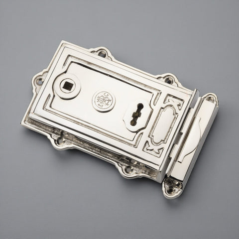 Polished nickel Davenport rim lock shown at an angle highlighting decorative detailing and keyhole